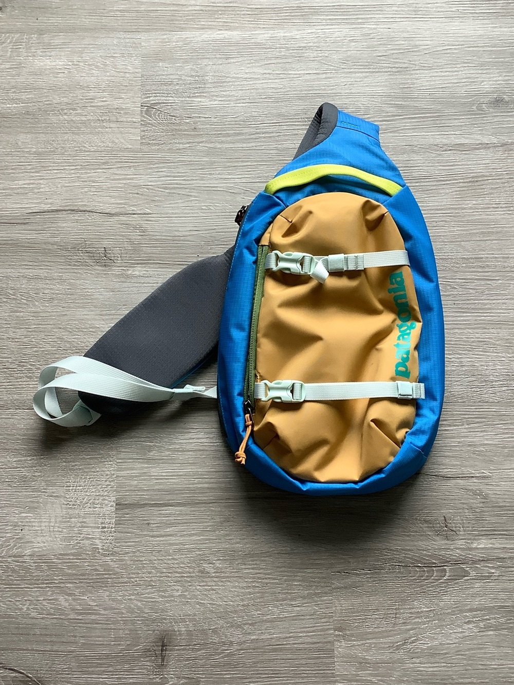 Patagonia Atom sling bag in blue & brown